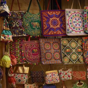A vibrant collection of traditional embroidered handbags showcasing intricate patterns.